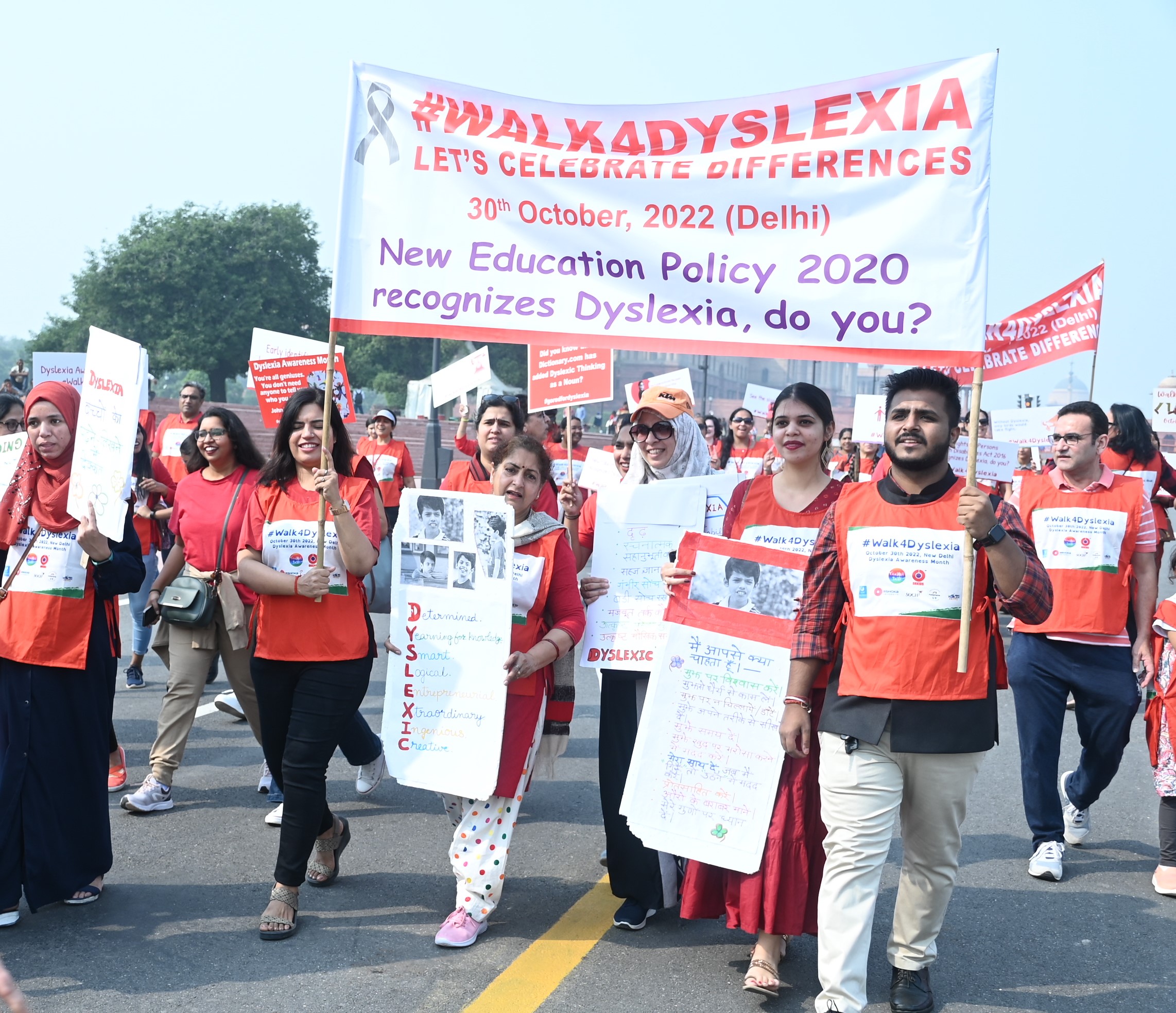 Participants of Walk4Dyslexia walking with a banner and posters to generate dyslexia awareness